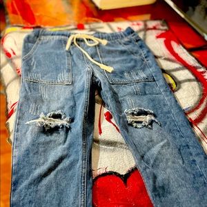 Distressed drawstring blue jeans;never worn but look “broken-in”.